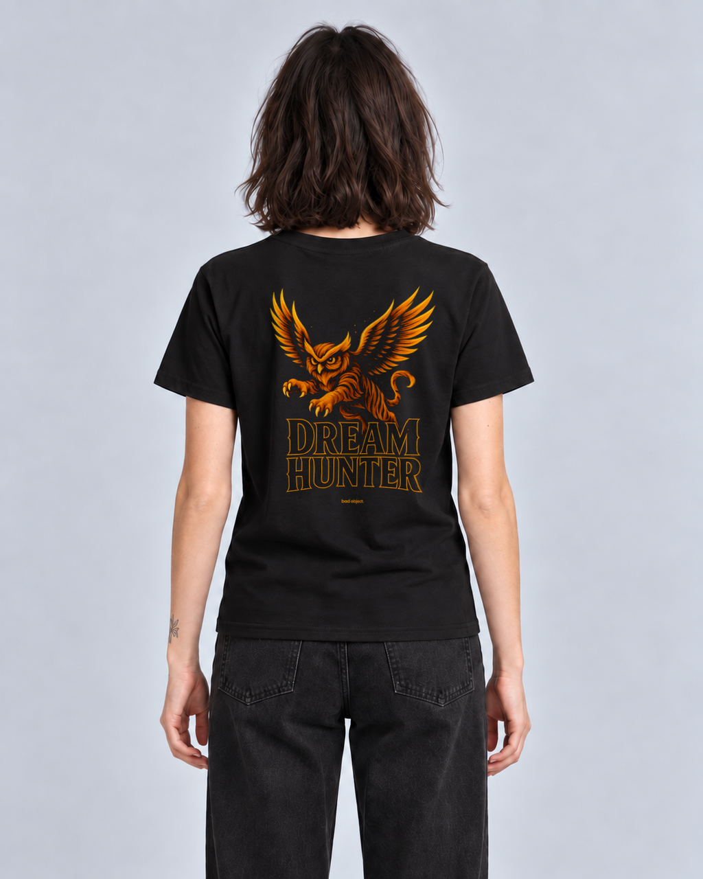Dream Hunter Black Classic T-shirt on a female model, back artwork with small amber bad object. signature