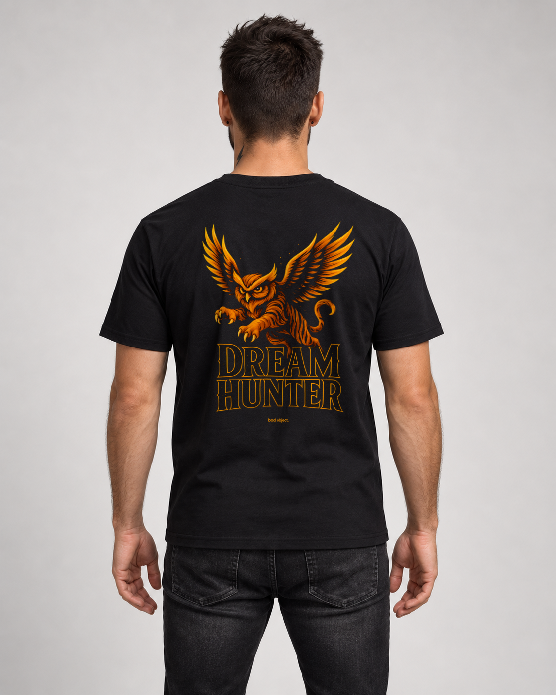Dream Hunter Black Classic T-shirt on a male model, back artwork with small amber bad object. signature