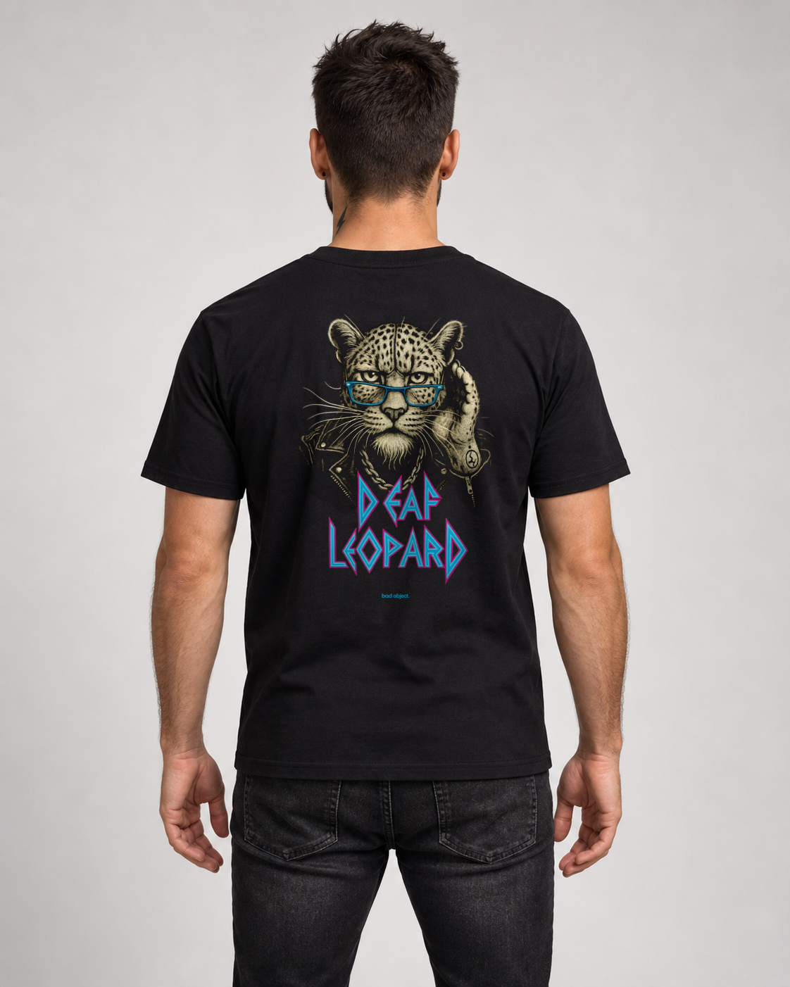Deaf Leopard black Classic T-shirt on a male model, back view with cyan bad object. signature